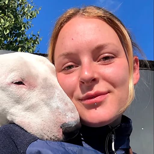 Ellie with a bull terrier resting its head on her shoulder